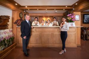 a man and a woman standing in front of a bar at KC Place Hotel Pratunam - SHA Extra Plus Certified in Bangkok