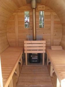 an inside of a sauna with two benches and a stove at Le Péché de Paresse in Saint-André-en-Vivarais