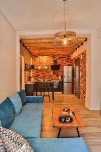 a living room with a blue couch and a table at LM Luxury Central Loft in Larisa +20 photos