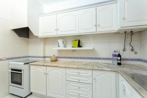A kitchen or kitchenette at Fresh Sunny Flat with Pool & Terrace by Host Wise
