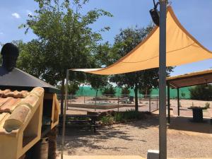 a yellow umbrella on a pole in a park at La Huerta el Bao in Alhambra