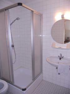 a bathroom with a shower and a sink at Hotel Ten Putte in Gistel