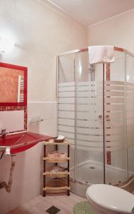 a bathroom with a shower and a red sink at Gabizz Apartments in Constanţa +189 photos