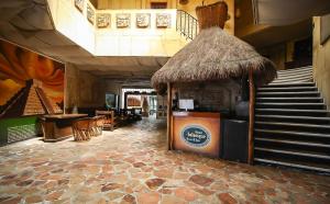 a restaurant with a bar and a staircase in a building at Hotel Xbalamqué Boutique & Spa in Cancún +137 photos