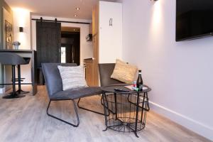 a living room with a chair and a table at Studio 23 in Zandvoort