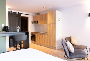 a kitchen with a counter and chairs in a room at Studio 23 in Zandvoort