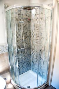 a shower with a glass enclosure in a bathroom at beb slowlife2 in Marina di Camerota