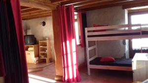 a room with two bunk beds with red curtains at Gite Seguret in Gresse-en-Vercors