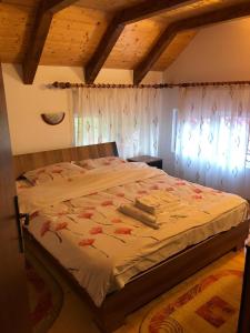 a bedroom with a large bed in a room at Casa Livada cu Meri in Vişeu de Jos +9 photos