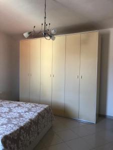 um quarto com armários brancos e uma cama em Casa Durante em Laurino
