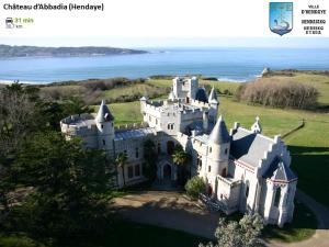 an aerial view of a castle with the ocean in the background at South West in Anglet