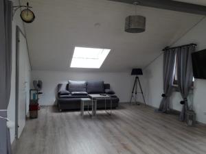 a living room with a couch and a skylight at Haus Helga in Füssen