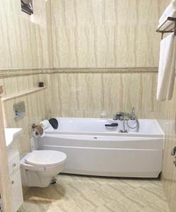 a bathroom with a white tub and a toilet at Vila Kalliopi in Eforie Nord +34 photos