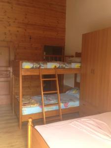 a room with two bunk beds in a room at Hotel Toni Llogora in Llogara