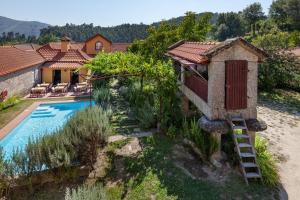 een afbeelding van een huis met een zwembad bij Casa do Eido - sustainable living & nature experiences Gerês in Geres