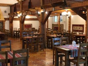 a dining room with wooden tables and chairs at Vila De Argint Aleea Pelesului Nr 2 in Sinaia