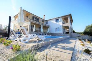 a villa with a swimming pool and a house at Villa Anna in Medulin