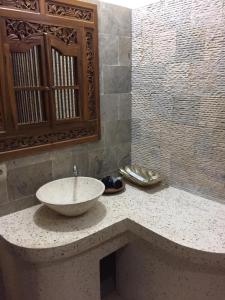 a bathroom with a bowl sink on a counter at Intan Mutiara Sanur Beach Villa in Sanur