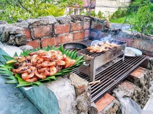 a bunch of shrimp cooking on a grill at Baan Heaven / Patong Beach Pool Villa Sleeps up to 15 in Patong Beach