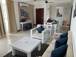 a living room with a couch and a table at 123 Ocean Front Condo in Nilaveli