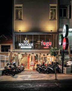 a group of motorcycles parked in front of a store at SO! Boutique Hostel in Malang
