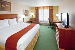 a hotel room with a large bed and a flat screen tv at Holiday Inn Express Hotel and Suites Valparaiso, an IHG Hotel in Valparaiso