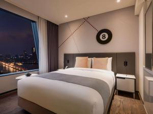 Postel nebo postele na pokoji v ubytování ibis Styles Ambassador Seoul Yongsan