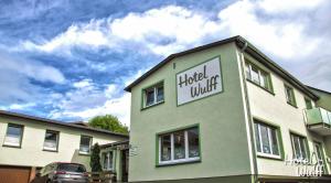 a building with a sign on the side of it at Hotel Wulff in Warburg