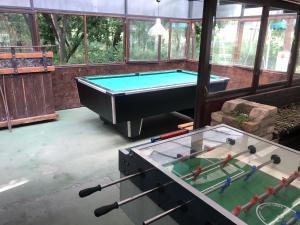 a pool table in the middle of a room at Tisza-beach wild camping 5 in Szeged