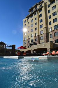 a view of a hotel with chairs in the water at Summit Hotel at Big Sky Resort in Big Sky