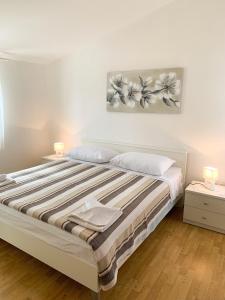 a bedroom with a bed with two candles on it at Apartments Ema in Sali