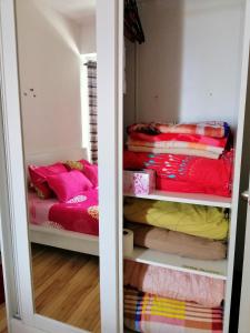 a room with a closet with two beds at Syafiq Suite in Kota Bharu