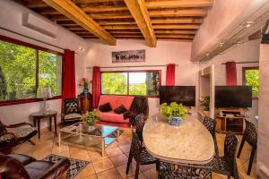 a living room with a table and chairs and a couch at Duché d'Uzès Villa Celina Avenue des Cévennes in Uzès