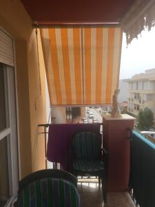 a balcony with a table and chairs and a window at Torrox costa apartamento in Torrox Costa