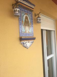 a painting on the side of a wall next to a window at Torrox costa apartamento in Torrox Costa