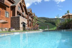 a large swimming pool in front of a building at Big Sky Resort Village Center in Big Sky
