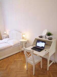 a desk with a laptop and a chair at Charles Bridge Premium Apartments in Prague