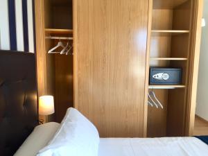 Łóżko lub łóżka w pokoju w obiekcie Portosín -Suites