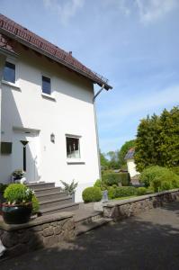 a white house with stairs and a window at Ferienhaus Luzia in Darscheid