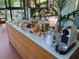 a breakfast buffet with food and a computer on top at Casale Al Solivo B&B in Castion Veronese