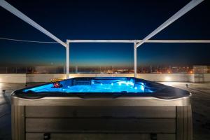 a hot tub on top of a building at night at Boutique Residence Cosmopolis 1 in Bibinje