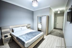 Postel nebo postele na pokoji v ubytování Hotel Wave