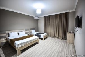 Postel nebo postele na pokoji v ubytování Hotel Wave