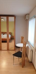 a room with a table and chairs and a bed at Gästezimmer Junglas in Bornheim