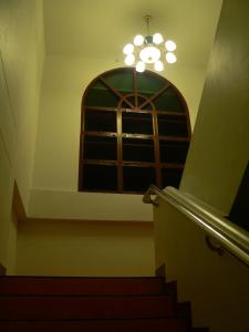 a stairway with a window and a set of stairs at โรงแรมตีฆ้อง - Tri Gong Hotel in Chiang Mai