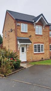 a brick house with a white door at Anvil Drive - Birmingham BnBs in Oldbury