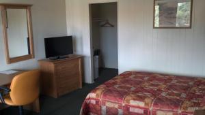 Postel nebo postele na pokoji v ubytování Heritage House Motel