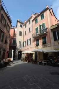 a group of buildings with tables in a street at Al nodo di Andrea Cod.Citra 011019-LT-0300 in Monterosso al Mare