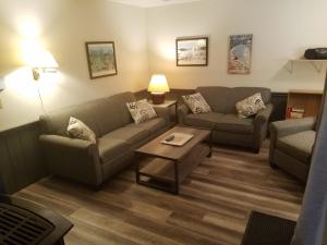 a living room with two couches and a coffee table at Ski in/out Spruce Glen Townhomes on Great Eastern Trail in Killington +21 photos