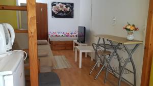 a small room with a small table and a bed at B&B Veber in Bilje